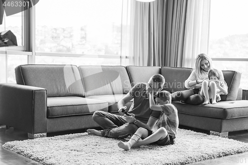 Image of Happy family playing a video game