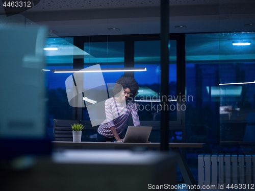 Image of black businesswoman using a laptop in startup office