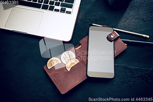 Image of The golden bitcoin, phone, keyboard