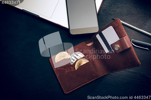 Image of The golden bitcoin, phone, keyboard