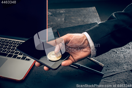 Image of The golden bitcoin in mail hands