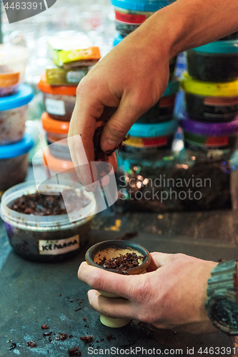 Image of Shisha hookah preparing by barman.