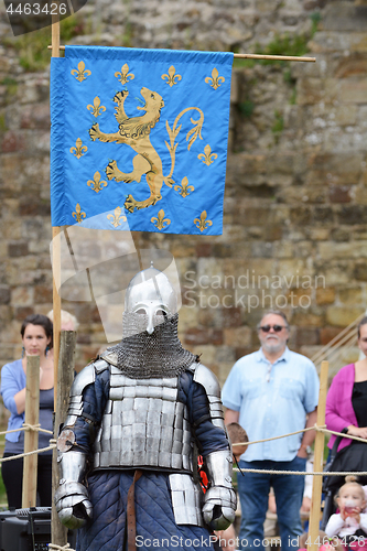 Image of Medieval knight in full battle armour prepares to fight