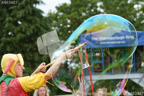 Image of Bosco the jester produces a large bubble for spectators