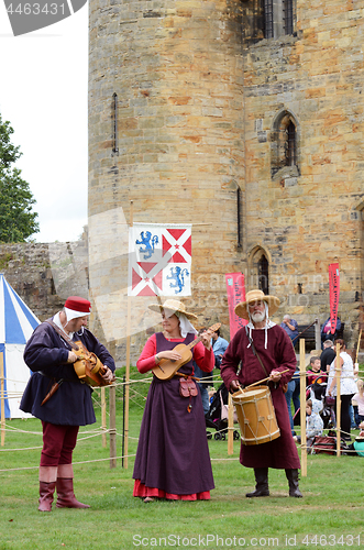 Image of Three musical minstrels perform on authentic instruments from th