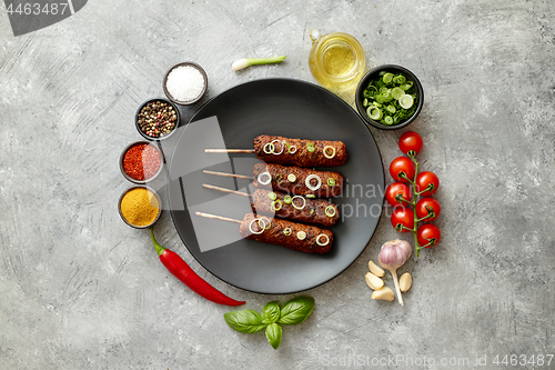 Image of Barbecued turkey kebab decorated with fresh onion