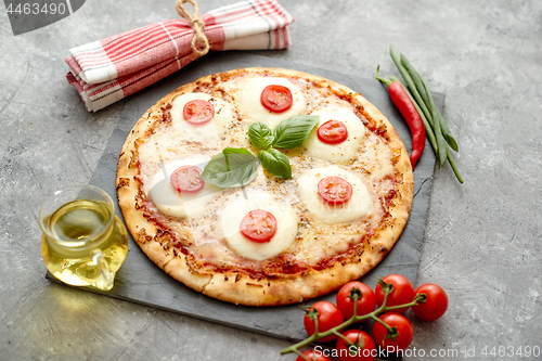 Image of Homemade pizza with tomatoes, mozzarella