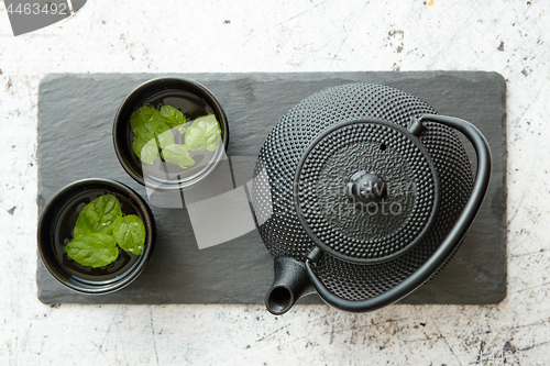 Image of Traditional eastern metal teapot and iron cups