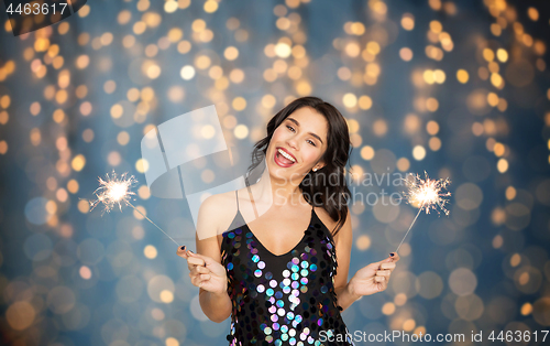 Image of happy young woman with sparklers at party