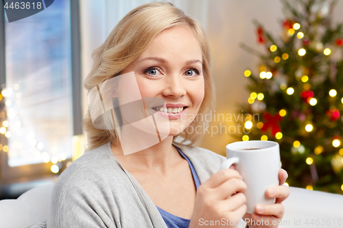 Image of woman with cup of tea or coffee on christmas