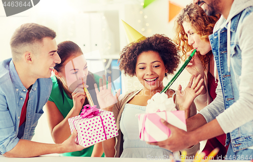 Image of team greeting colleague at office birthday party