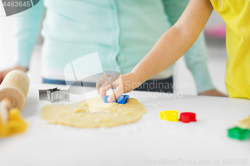 Image of mother and daughter making cookies at home