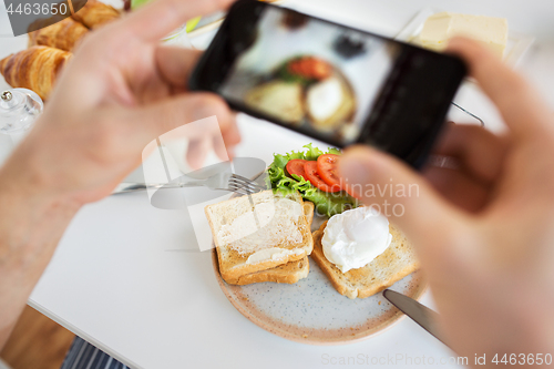 Image of hands with smartphones photographing food