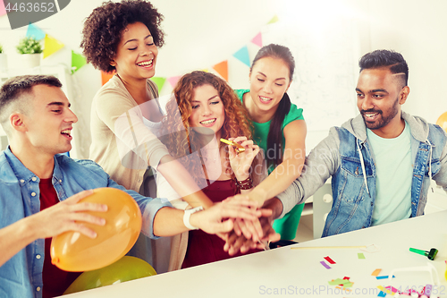 Image of happy business team at office party holding hands