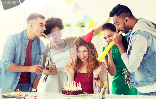 Image of team greeting colleague at office birthday party