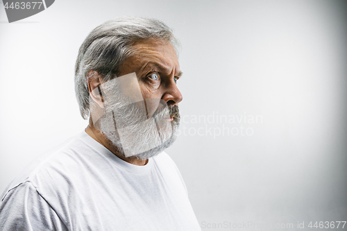 Image of The senior attractive man looking suprised isolated on white