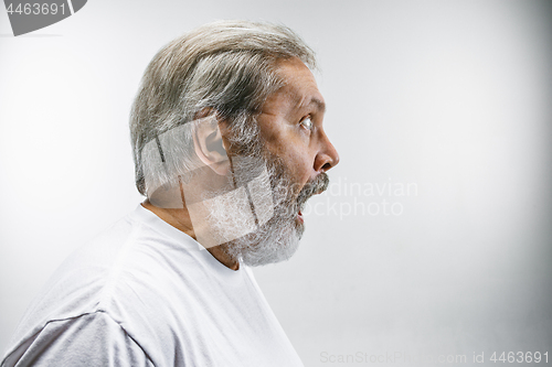 Image of The senior attractive man looking suprised isolated on white