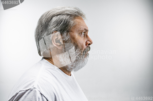 Image of The senior attractive man looking suprised isolated on white