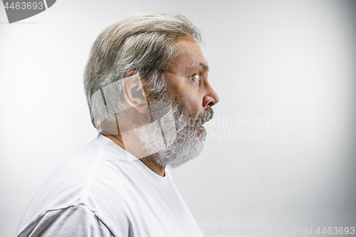 Image of The senior attractive man looking suprised isolated on white
