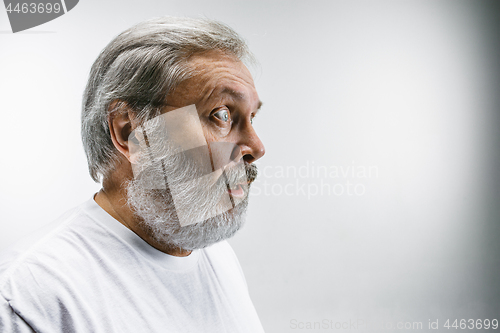 Image of The senior attractive man looking suprised isolated on white