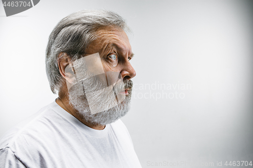 Image of The senior attractive man looking suprised isolated on white