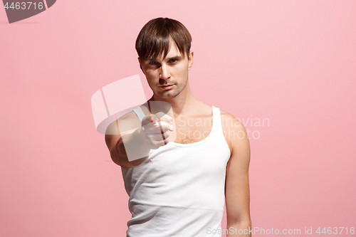 Image of The overbearing man point you and want you, half length closeup portrait on pink background.