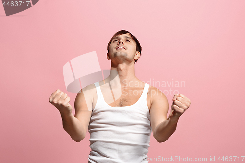 Image of Winning success man happy ecstatic celebrating being a winner. Dynamic energetic image of male model