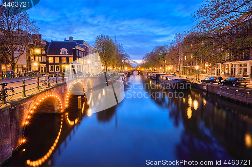 Image of Amterdam canal, bridge and medieval houses in the evening