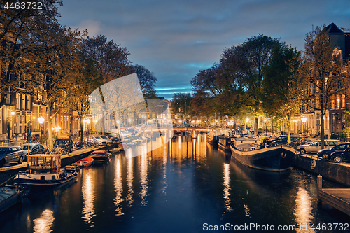 Image of Amterdam canal, bridge and medieval houses in the evening