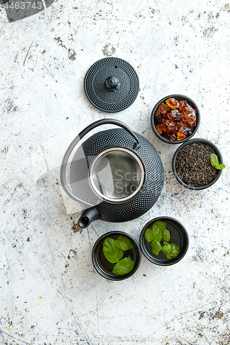 Image of Traditional eastern metal teapot and iron cups