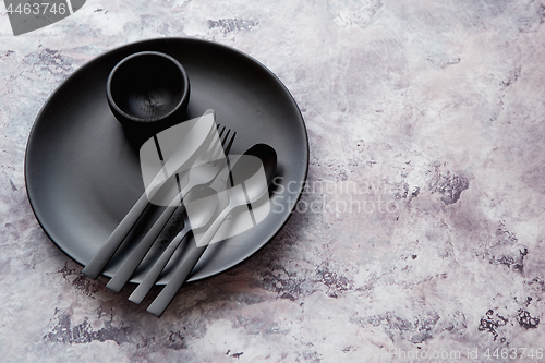 Image of Top view of black empty plate on marble stone background