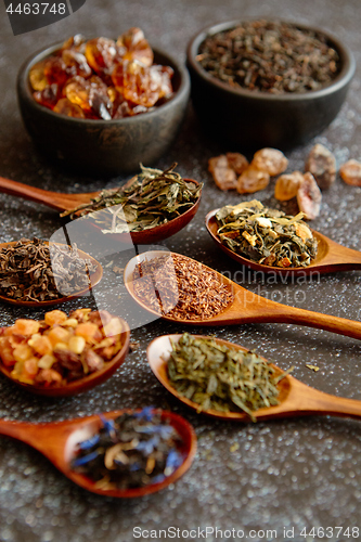 Image of Spoons with different types of dry tea leaves.