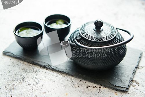 Image of Traditional eastern metal teapot and iron cups