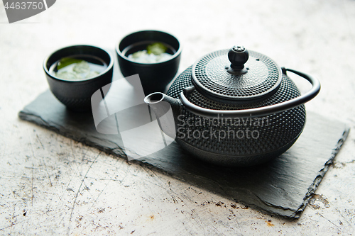 Image of Traditional eastern metal teapot and iron cups
