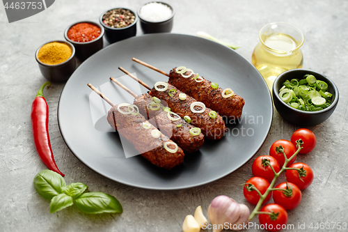 Image of Barbecued turkey kebab decorated with fresh onion