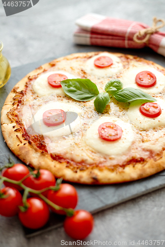 Image of Homemade pizza with tomatoes, mozzarella