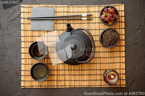 Image of Asian green tea set on bamboo mat