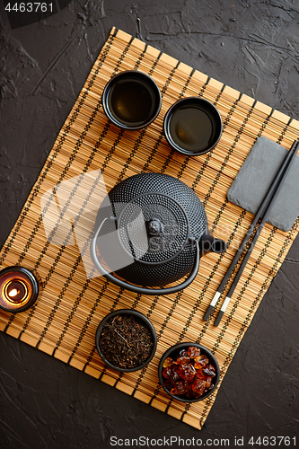 Image of Asian green tea set on bamboo mat
