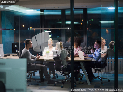 Image of Multiethnic startup business team in night office