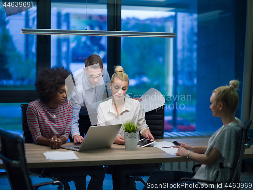Image of Multiethnic startup business team in night office
