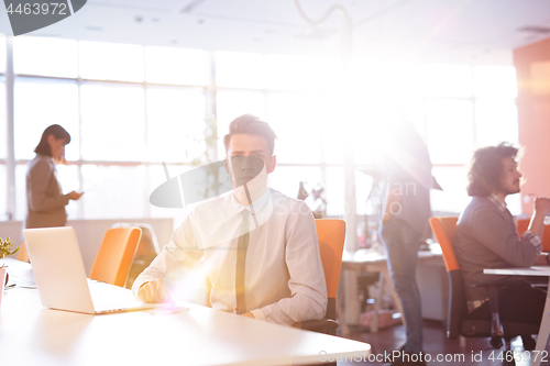 Image of Young businessman using computer at work