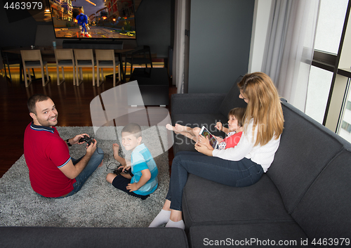 Image of Happy family playing a video game