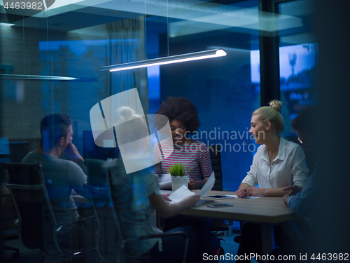 Image of Multiethnic startup business team in night office