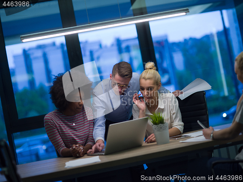 Image of Multiethnic startup business team in night office