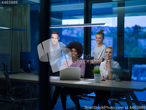 Image of Multiethnic startup business team in night office