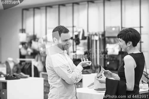 Image of couple chooses shoes At Shoe Store