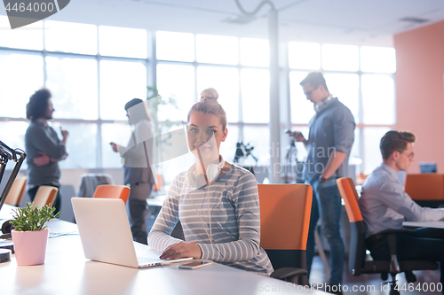 Image of businesswoman using a laptop in startup office