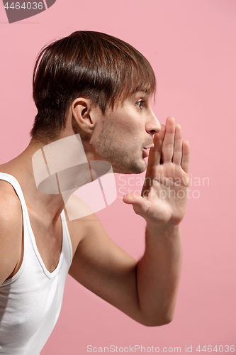 Image of Isolated on pink young casual man shouting at studio