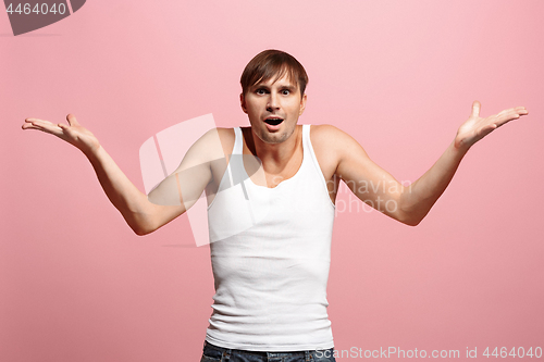 Image of Handsome man looking suprised isolated on pink