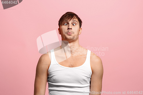 Image of The squint eyed man with weird expression isolated on pink